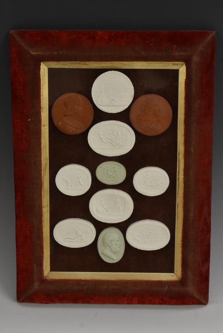 An arrangement of Grand Tour type plaster intaglios and: An arrangement of Grand Tour type plaster intaglios and cameos, 22.5cm x 13.5cm