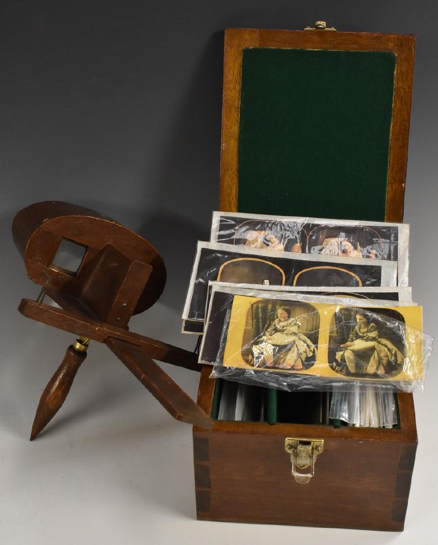 A 19th century stereoscopic viewer, of typical form,: A 19th century stereoscopic viewer, of typical form, 32.5cm long; 20th century erotic viewing cards, facsimiles of 19th and early 20th century photographs, (qty)