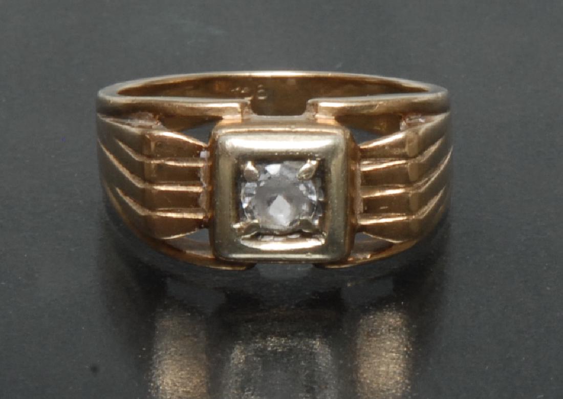 A 9ct gold stone set signet ring, unusual boxed crest: A 9ct gold stone set signet ring, unusual boxed crest inset with a single round cut white gemstone, possibly rock crystal quartz, raised above shaped open shoulders, tapering shank, stamped 9ct, size