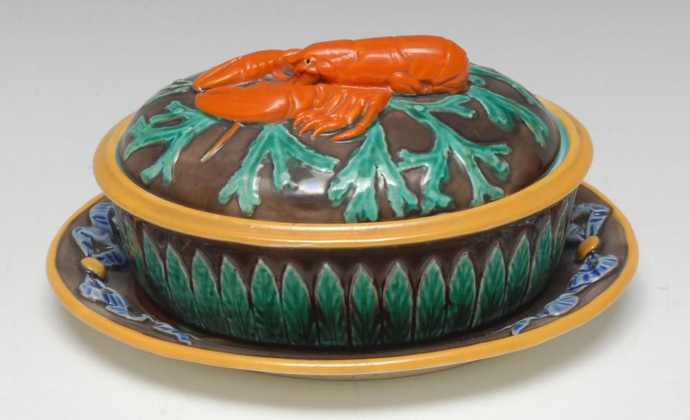 A Wedgwood majolica lobster tureen and cover, in relief: A Wedgwood majolica lobster tureen and cover, in relief with stiff leaves, the cover with orange lobster on a bed of weed, 19cm wide, impressed marks, c.1871