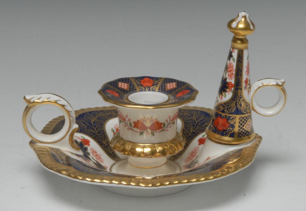 A Royal Crown Derby Old Imari 1128 pattern chamber: A Royal Crown Derby Old Imari 1128 pattern chamber stick and snuffer, 15cm diam, printed mark, boxed