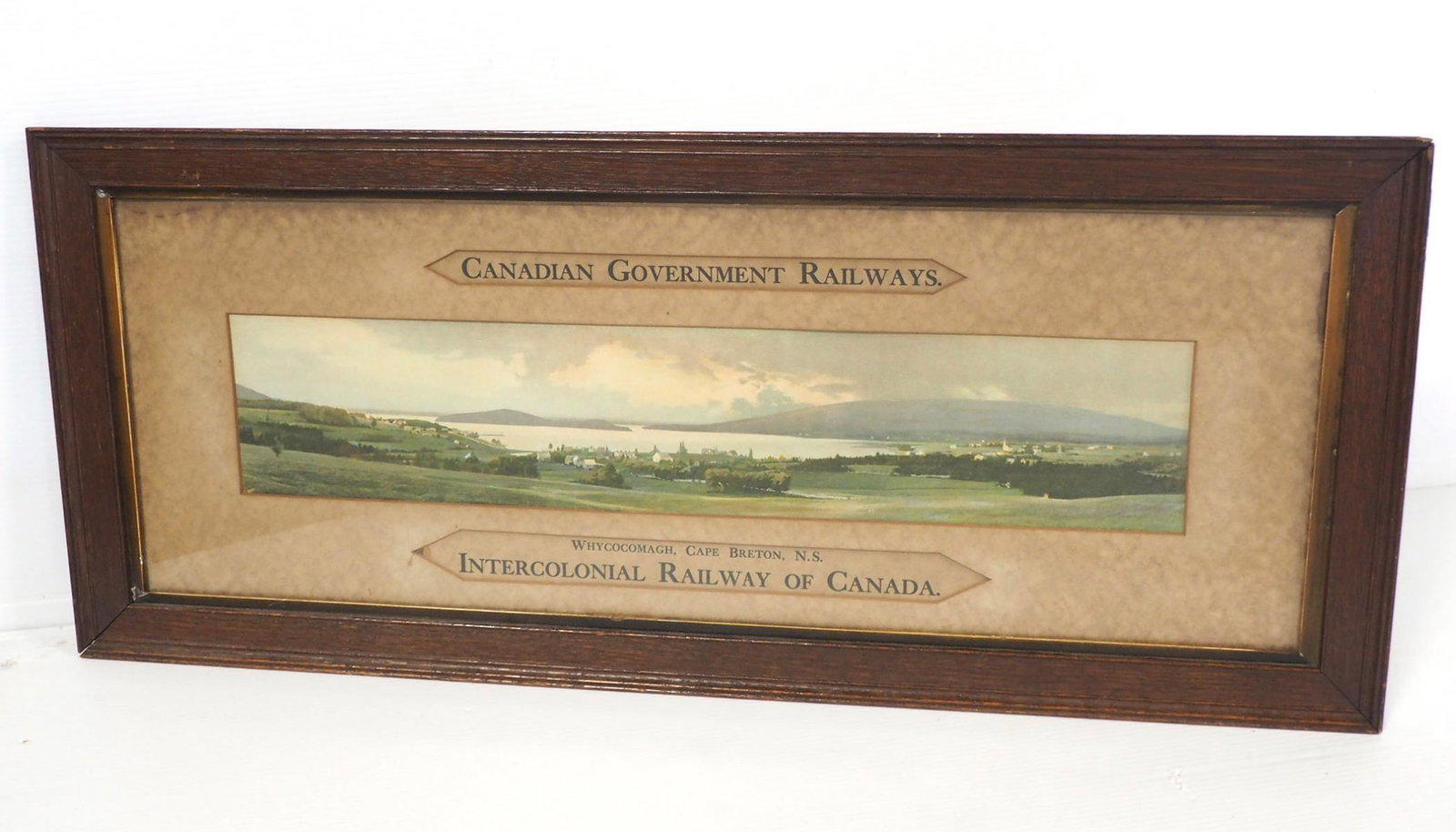 Canadian Govt. Railways sign: 33"x14" framed cardboard Canadian Govt. Railways advertising sign, hung in ticket office -Good