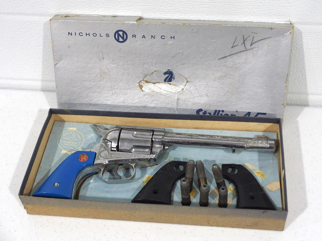 Nichols Ranch 2nd Model Stallion 45 cap gun: Nichols Ranch 2nd Model Stallion 45 cap gun with RARE blue grips, bullets & extra grips and box -Good, gun functions well, box is rough