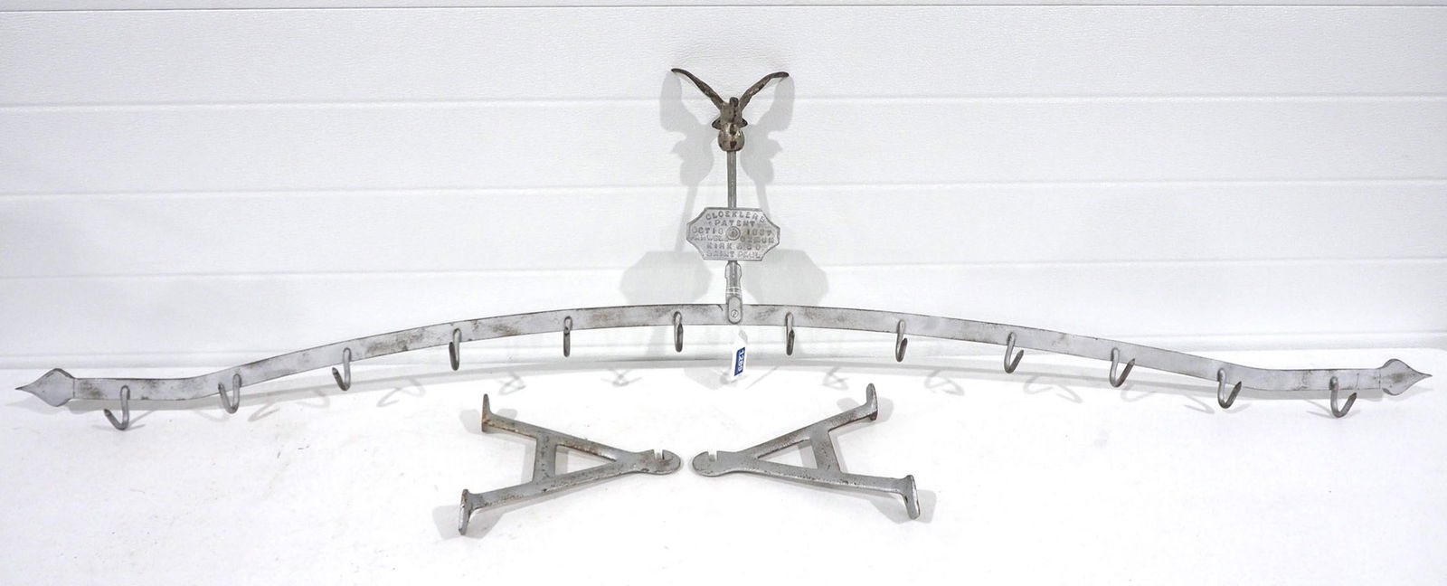 Gloekler's Butchers meat hook rack: 6'L Gloekler's Butchers meat hook rack with 2 wall mounts, dated 1887, has eagle emblem >>Buyer to arrange shipping