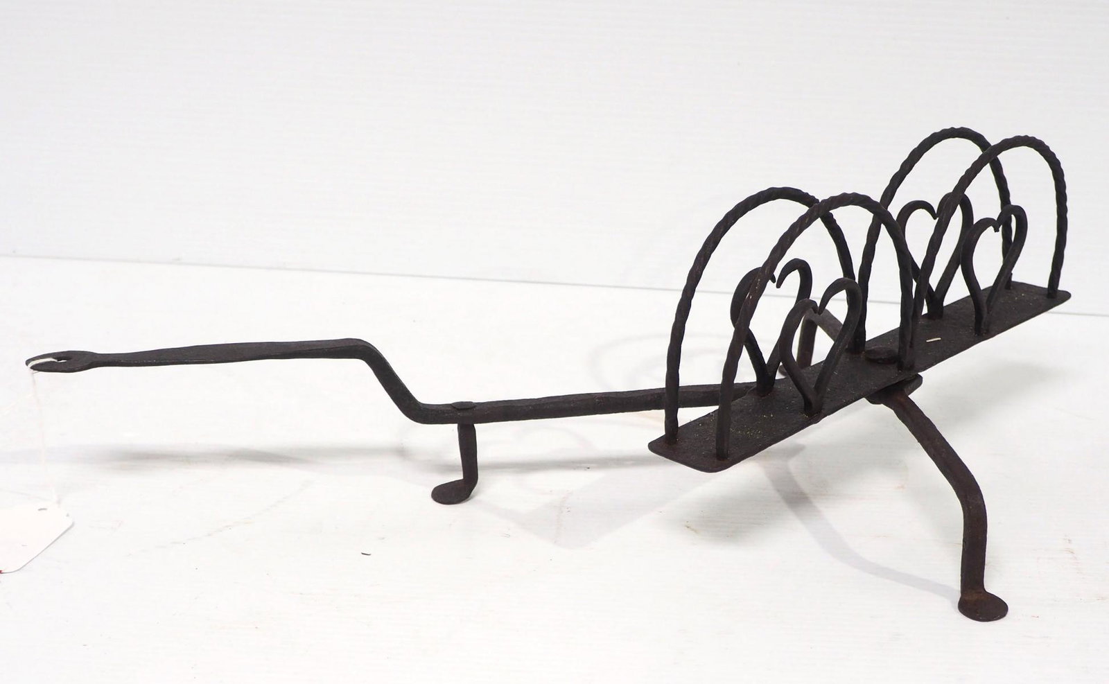 Early spinning fireplace toaster: Early hand-forged spinning fireplace toaster with heart designs