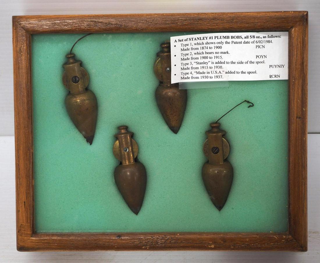 (4) Stanley No.1 Plumb Bobs: (4) Stanley No.1 Plumb Bobs, all 5/8 oz, in display case: Type 1 with patent date, Type 2 with no mark, Type 3 marked Stanley on spool, Type 4 marked Made in U.S.A on spool