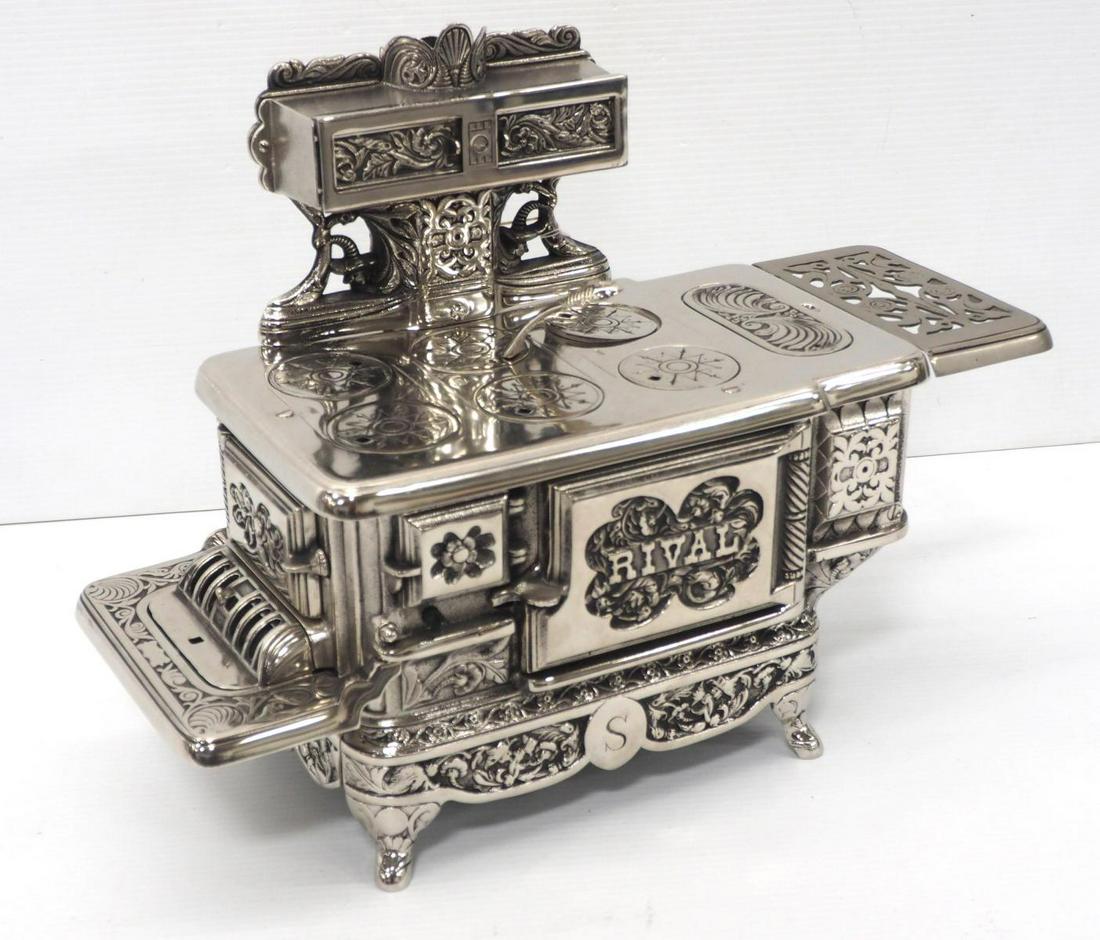 Child's stove by J & E Stevens Co.: Child's stove by J & E Stevens Co., ornate cast iron with beautiful nickel plating, pat'd July 30, 1895, complete with warming oven, 13½"H x 18"W -Very Good, replaced side shelf