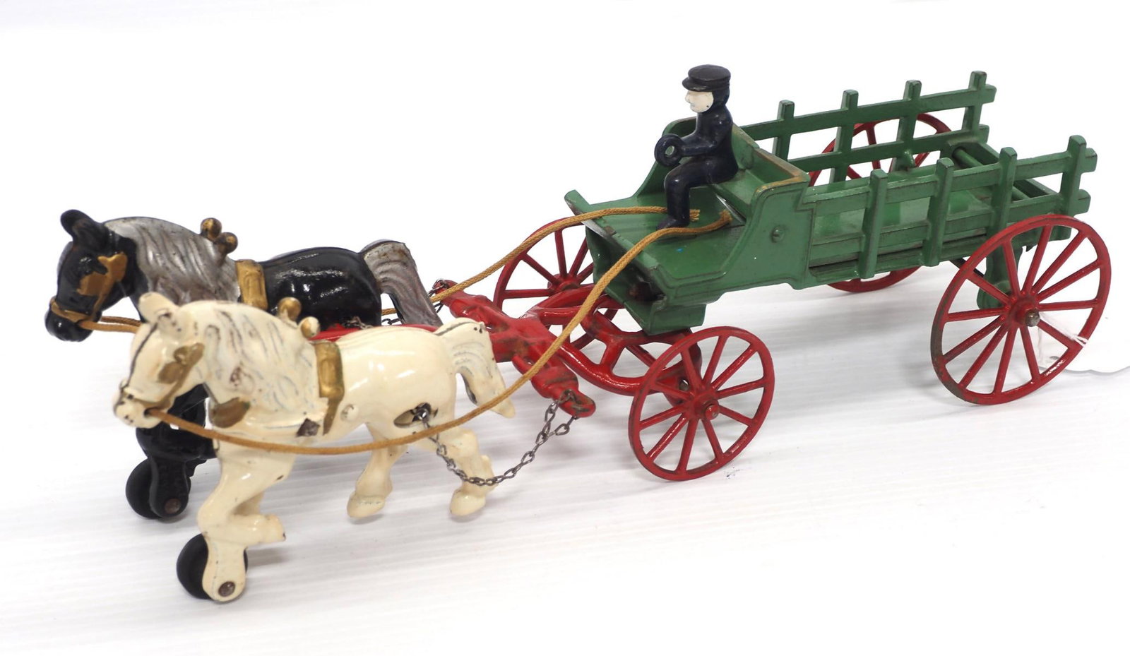 Kenton cast iron team of horses hitched to wagon: 14.5"L Kenton cast iron team of horses hitched to wagon, comes with driver -Very Good, Back axle of wagon has been replaced