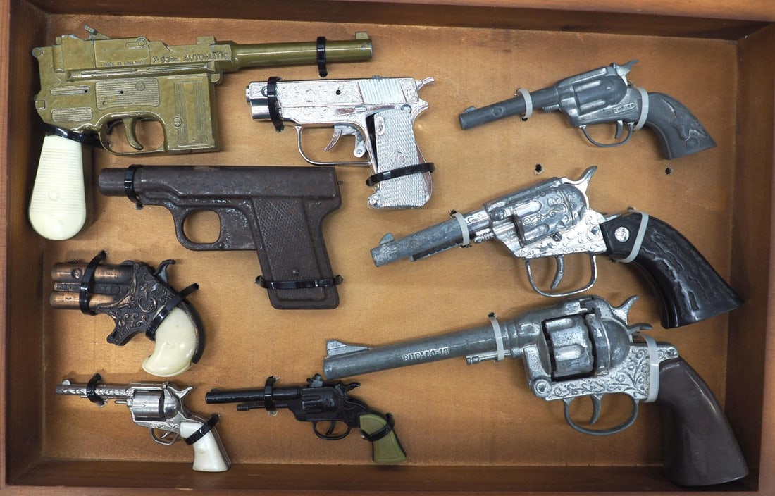 (9) Different cap gun toy pistols: Display case with 9 different cap gun toy pistols