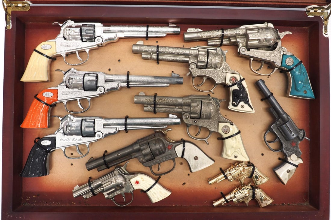 (11) Different cap gun toy pistols: Display case with 11 different cap gun toy pistols
