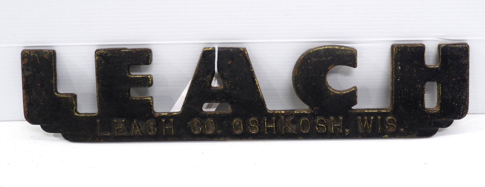 Cast Iron sign: 20"x4" cast iron Leach Co. OshKosh, Wis. sign