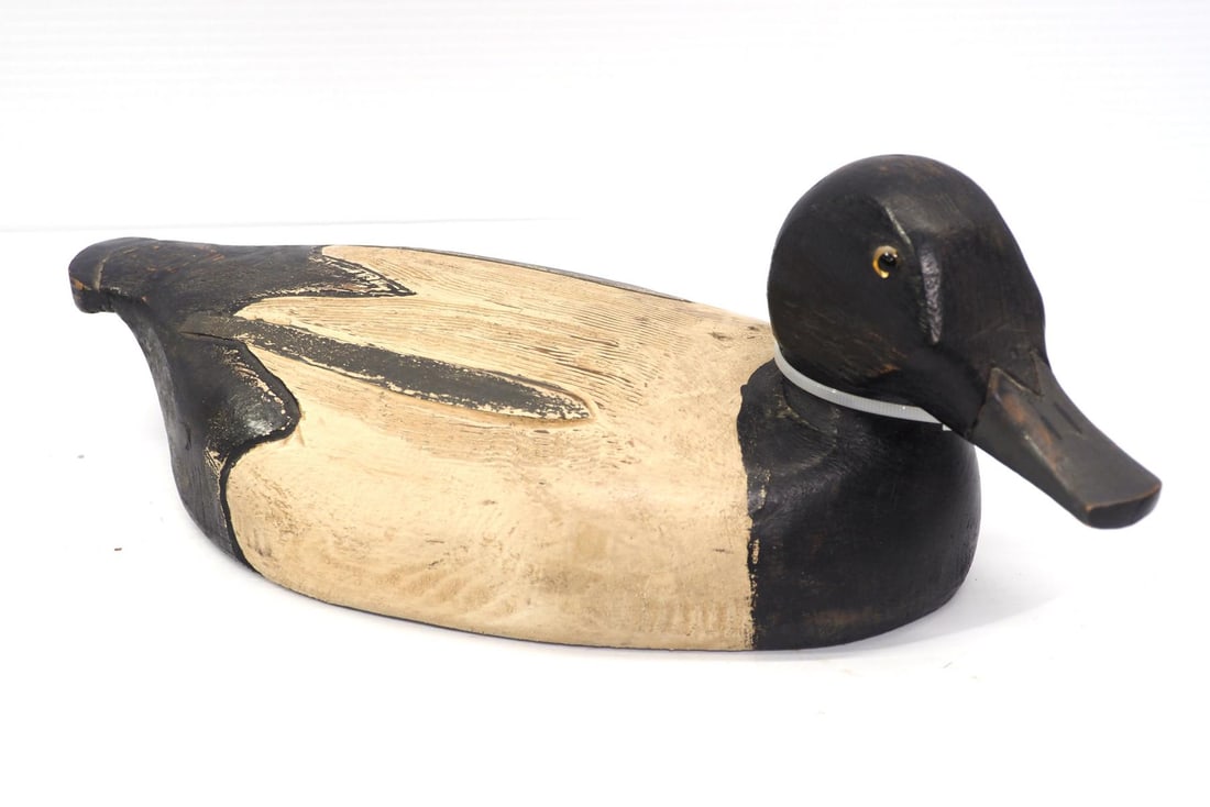 Wooden duck decoy: Wooden duck decoy marked C. Jensen Ludington, MI on bottom