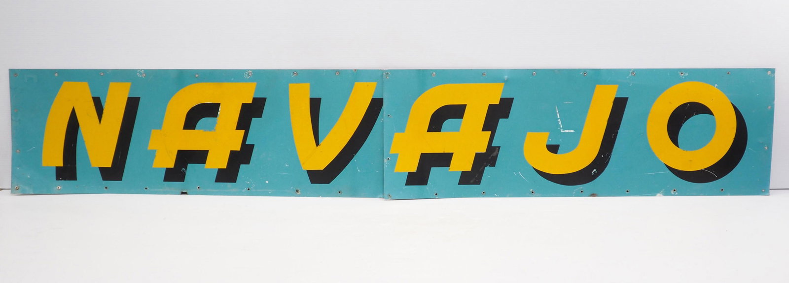 2-piece SST Navajo sign: 85"x14" 2-piece SST Navajo sign - Has 1"x.5" piece of tin missing on bottom, an extra hang hole, otherwise good