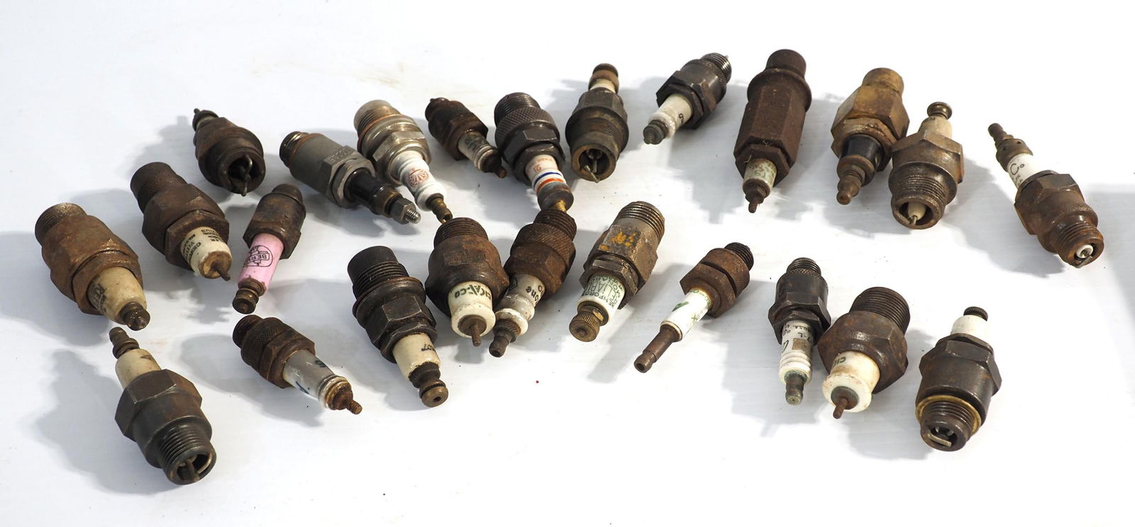 (24) Various porcelain spark plugs: (24) Various porcelain spark plugs ***These items are not located at the Chupp Auctions facility and will not be available for preview until April 1. As a result, some questions/info requests will not