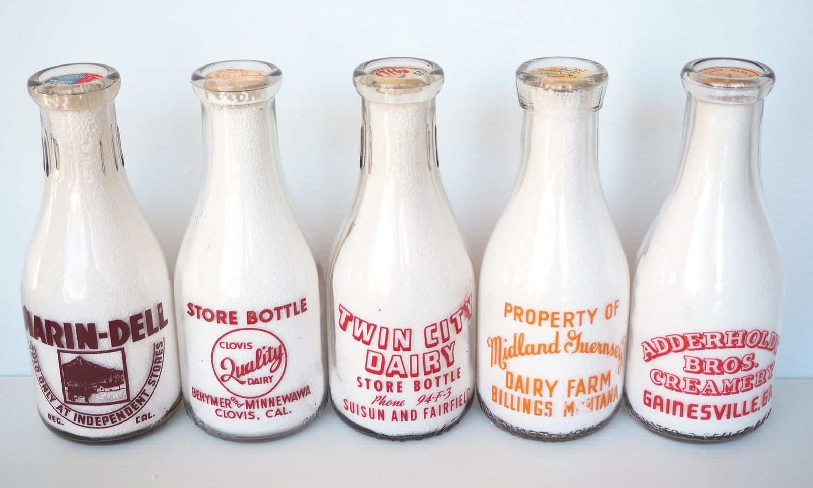 (5) 1 quart 'war slogan' milk bottles (1 of 2)