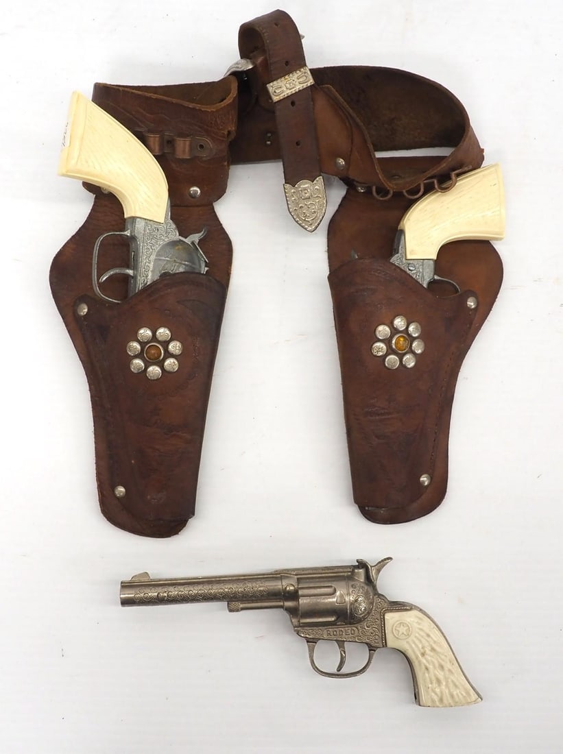 (3) Cap guns and a holster: Gabriel Texas Ranger holster with pair of cap guns and Hubley Rodeo cap gun - all Good