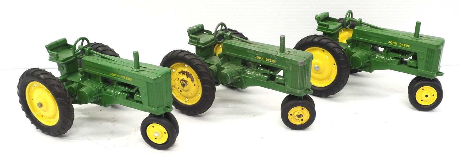 (3) John Deere Tractors: (3) 1/16 scale John Deere Tractors - 2 Excellent, 1 Fair