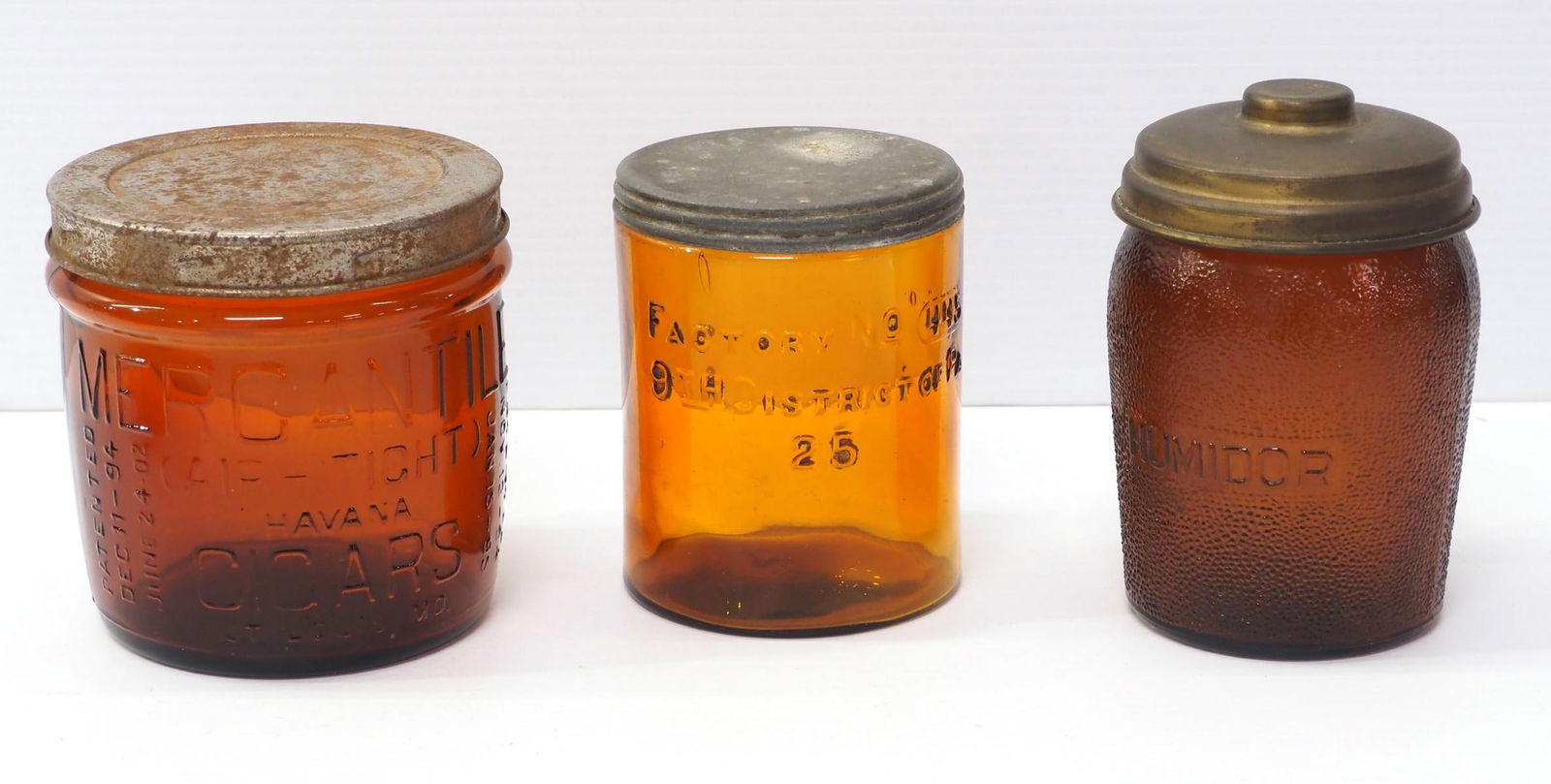 (3) Glass amber jars with tin lids: (3) Glass amber jars with tin lids: Havana Cigars -rough rim / Humidor / Factory No.445, 9th District of PA -rough rim