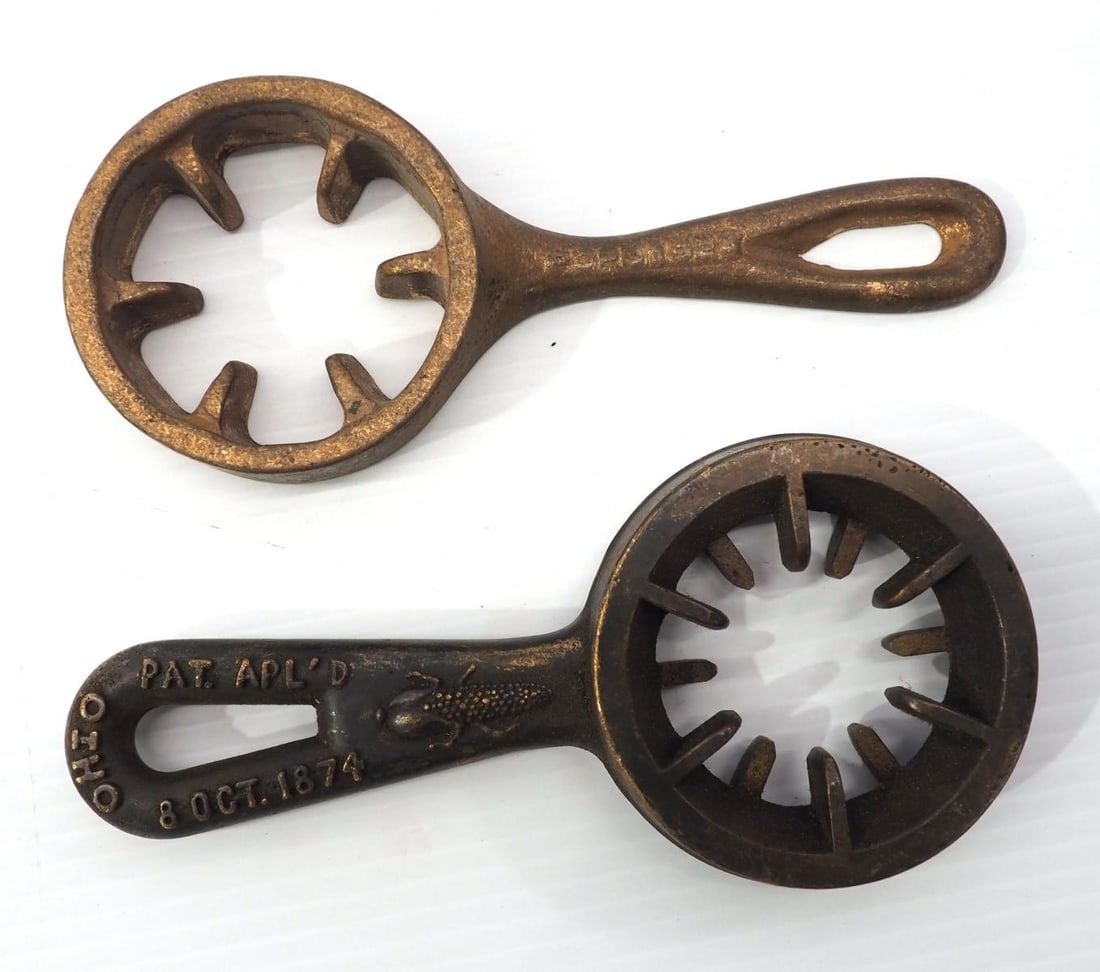 (2) Bronze skillet-type hand corn shellers: (2) Bronze skillet-type hand corn shellers with early patent dates that are not correct, see pg 135 of the Moffet book