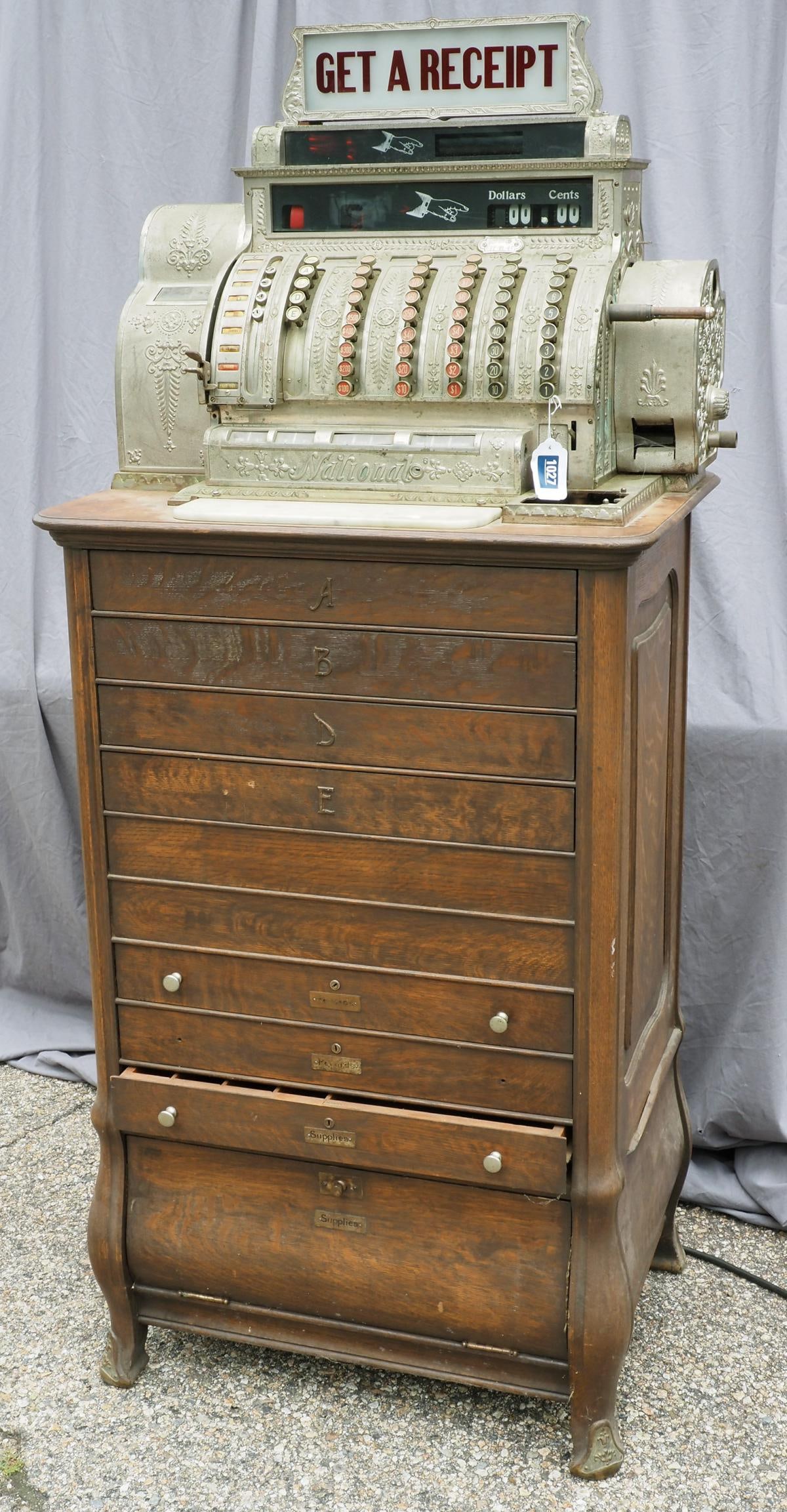 National Cash Register floor model register: National Cash Register model #597-EL-AF on floor model wooden base with drawers, serial #1078826, 29" x 21" x 67"H -Cracked rear receipt panel, replaced glass *NOTE: BUYER TO ARRANGE PICKUP. This item