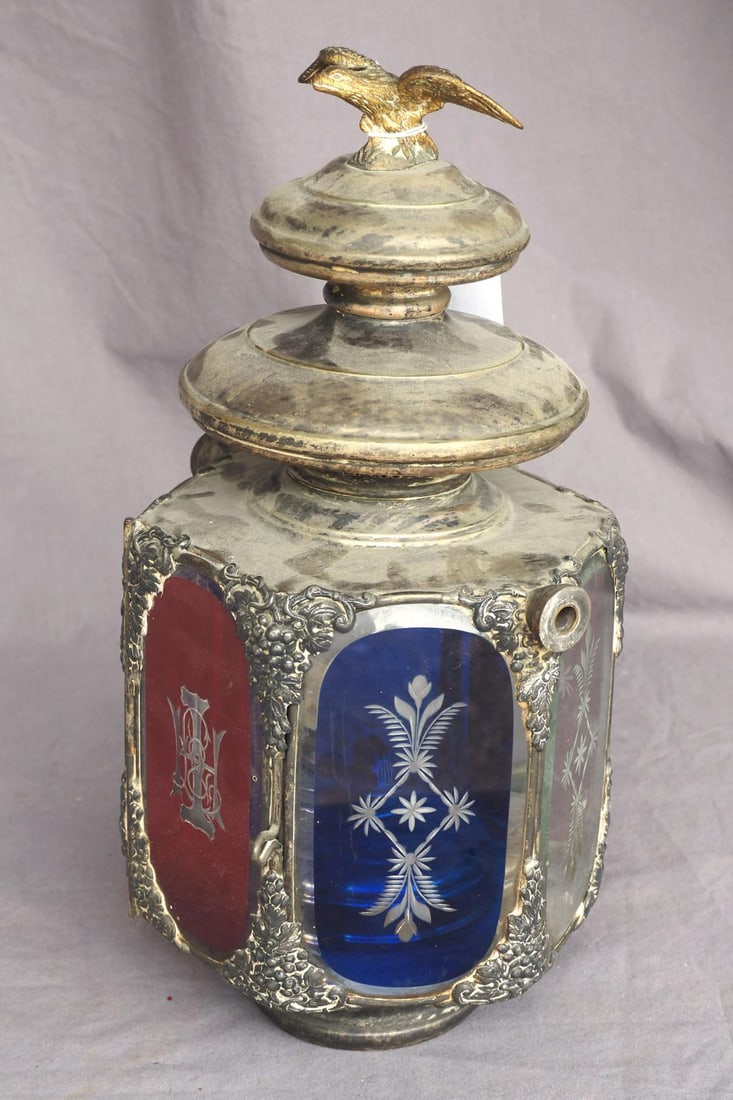 Early fireman wagon lamp: Early fireman wagon lamp with red, blue and clear glass panels and eagle finial, 15"H -Some tarnishing *NOTE: This item will be packaged and shipped when we return to our Indiana facility the week of 