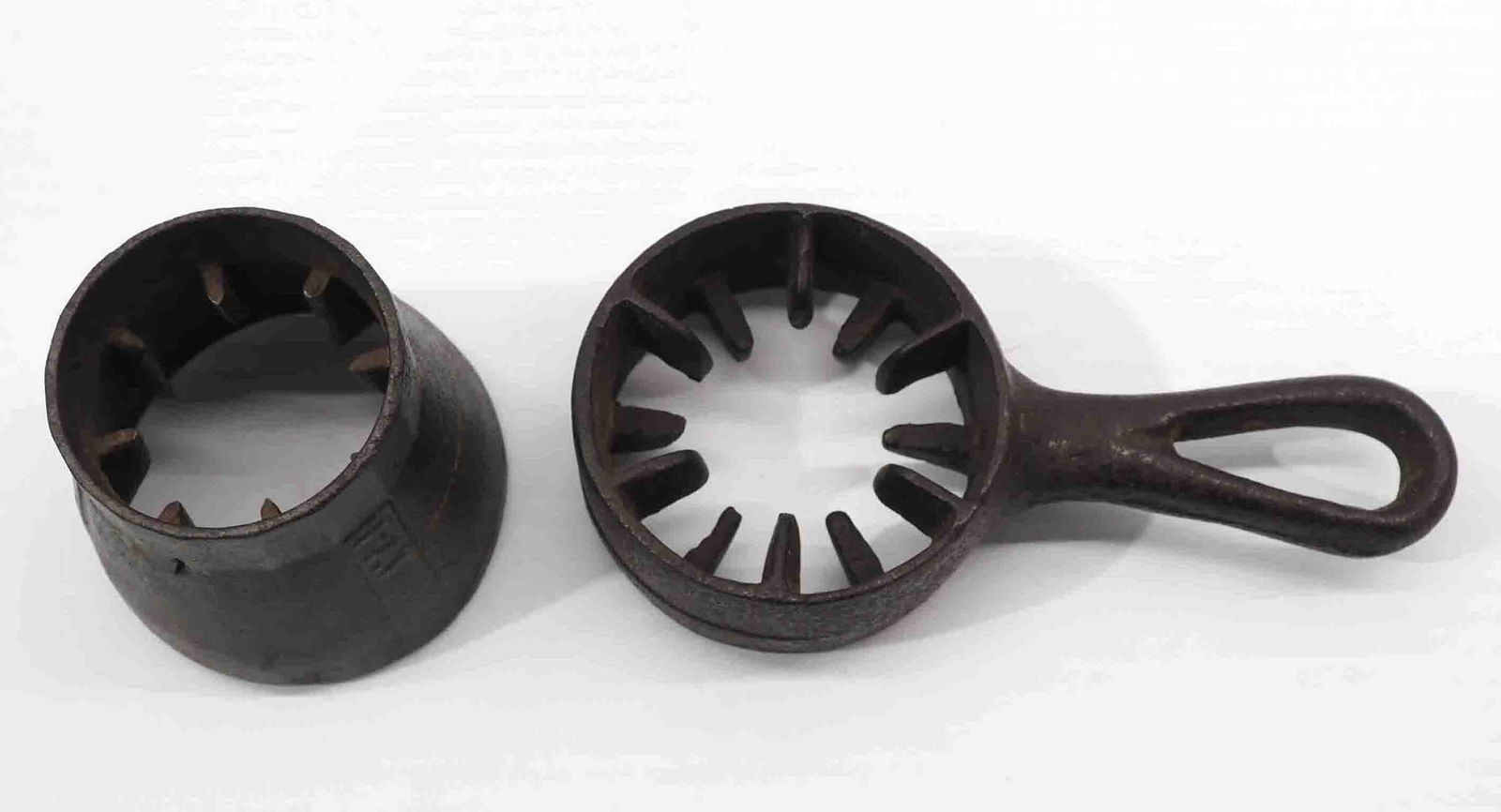 (2) Corn shellers: Cast iron skillet-type hand corn sheller / Cast iron round corn sheller