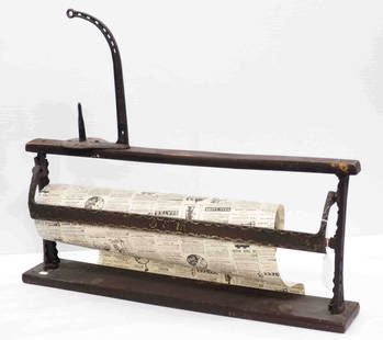Country store wrapping paper dispenser: 29"L Country store wrapping paper dispenser with cast iron supports, patent No.4, '90 with Simples string holder, patent April 14, '96