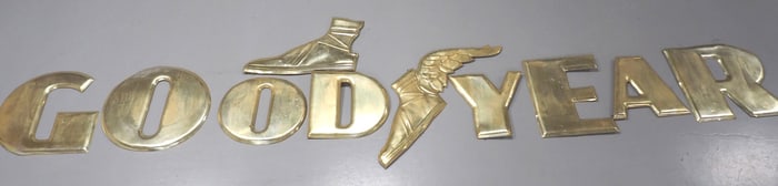 Goodyear tin letters and flying shoe sign