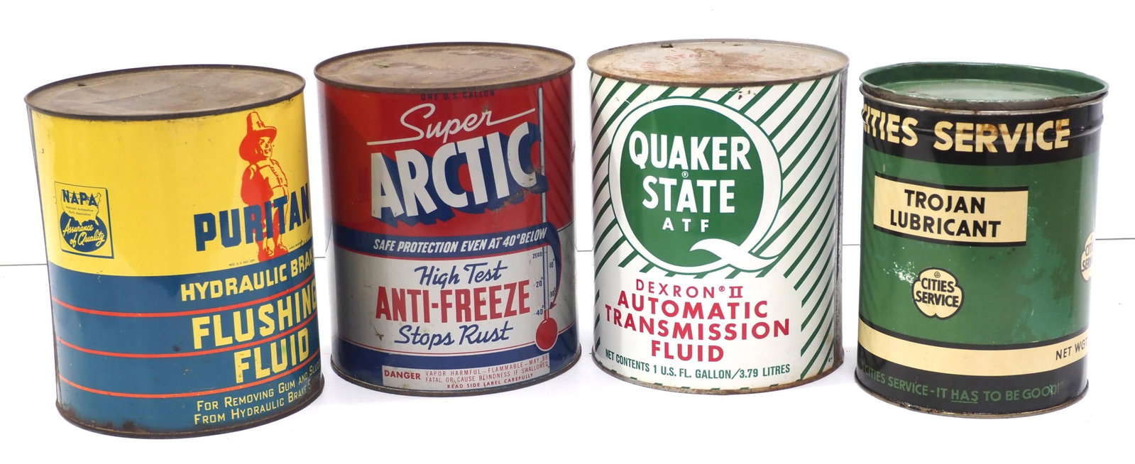 (4) Petroleum product tins: (4) Petroleum product tins: 1-gal Quaker State Transmission Fluid / 1-gal Arctic Antifreeze / 1-gal Puritan Flushing Fluid / 5-qt Cities Service Trojan Lubricant