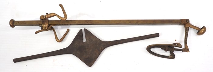 Brass piece marked The Moland / cast iron hand tool