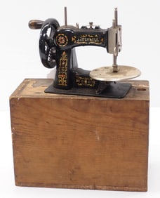 Stitchwell toy sewing machine in original wooden box with partial label on top
