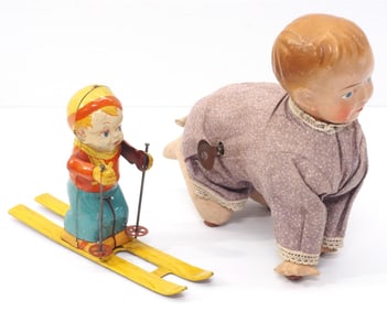 Wind-up, crawling baby doll "Gee" with tag for WalkingToys / Tin litho skiing child by J. Chein