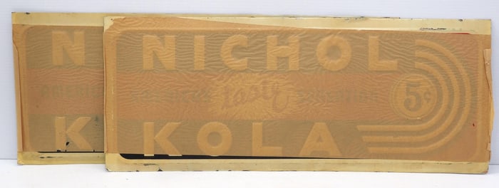 (2) NOS 27.5"x11" SST embossed Nichol Kola signs with original shipping paper stuck on