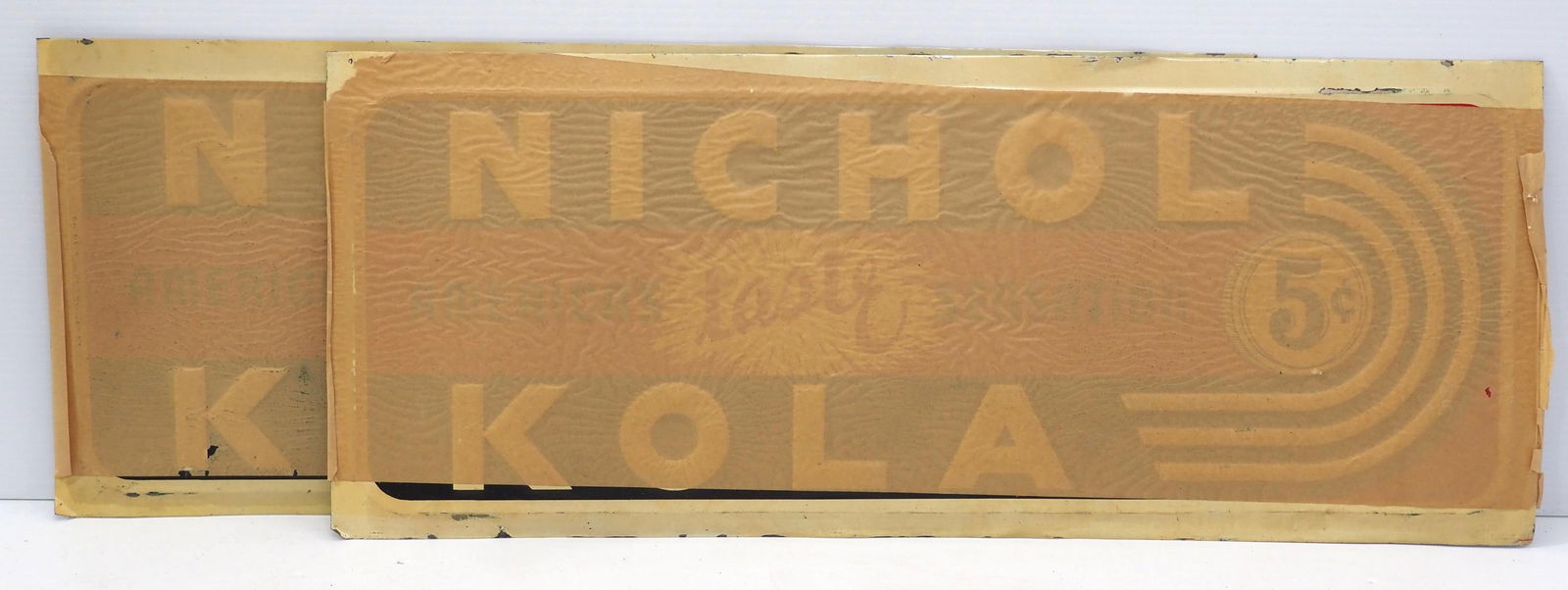 (2) NOS 27.5"x11" SST embossed Nichol Kola signs with original shipping paper stuck on (1 of 2)