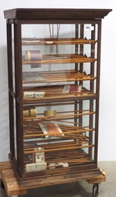 Floor model ribbon cabinet with 2 swinging doors, 25"x22"x48"H