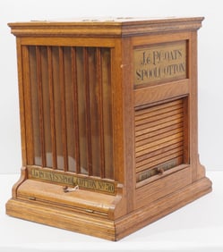 J&P Coats Spool Cotton oak spool cabinet with advertising on all 4 sides and some product,