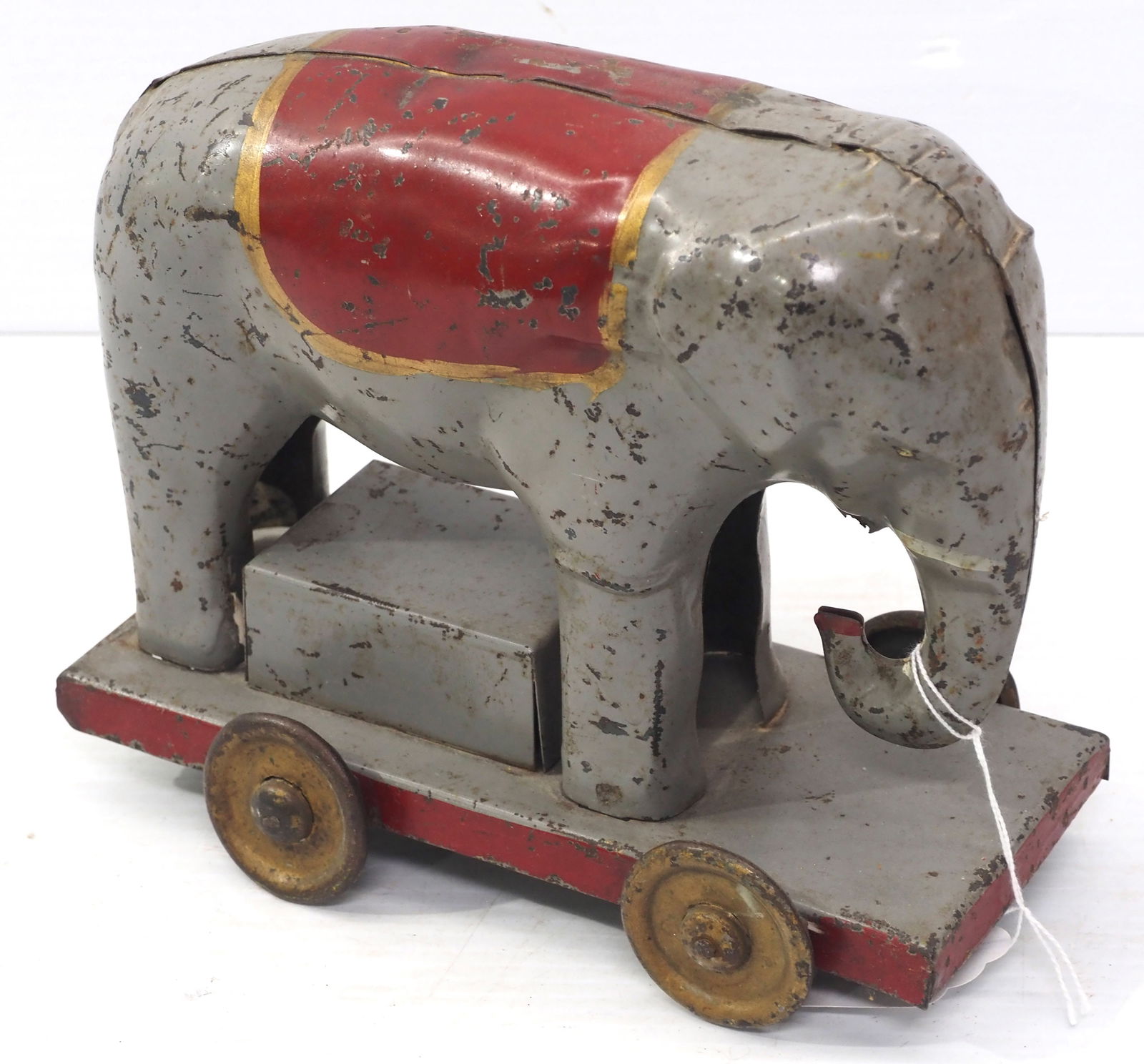 Early tin friction-type tin elephant toy: Early tin friction-type tin elephant toy with some original paint, 9"L x 8"H - Fair