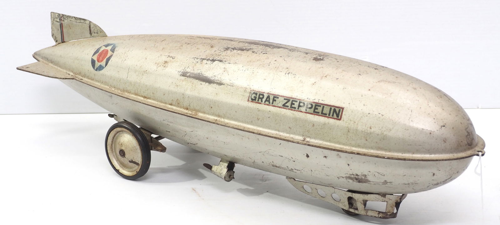 Graf Zeppelin child's pull toy: Pressed steel Graf Zeppelin child's pull toy with partial labels, 30.5"L
