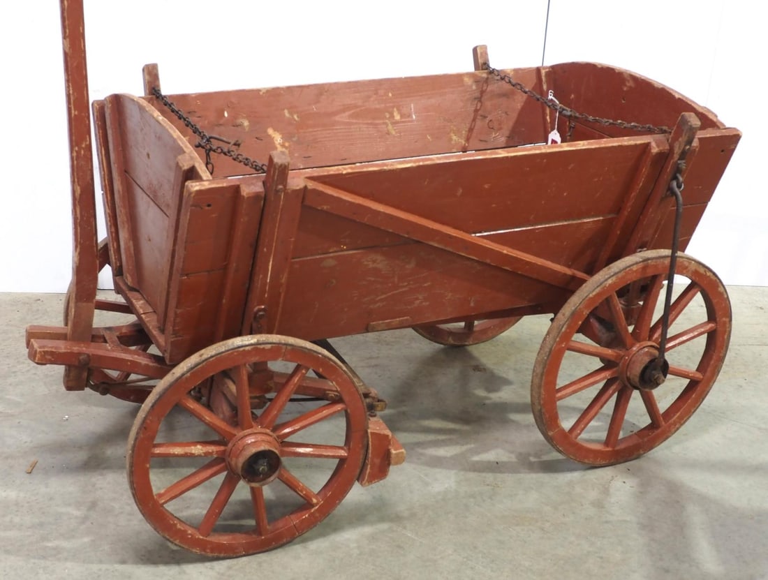 Large wooden pull wagon: Large wooden pull wagon with original red paint, 32"x32"x55"L plus handle * * White Glove Delivery available, please contact the auction house for details and a quote.