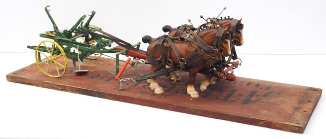 Custom metal cultivator hitched to horses