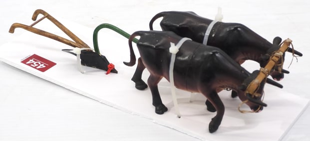 (2) Oxen pulling a small walking plow