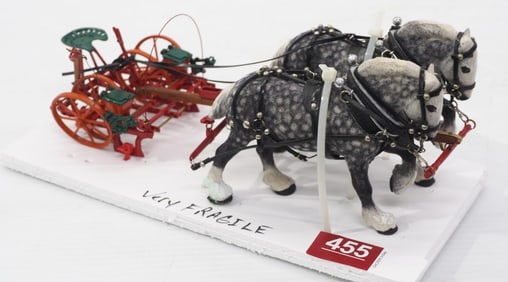 Team of grey horses hitched to a 2-row planter