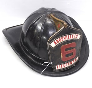 Fireman helmet with leather badge