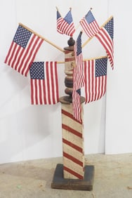 Wooden barber pole with flags