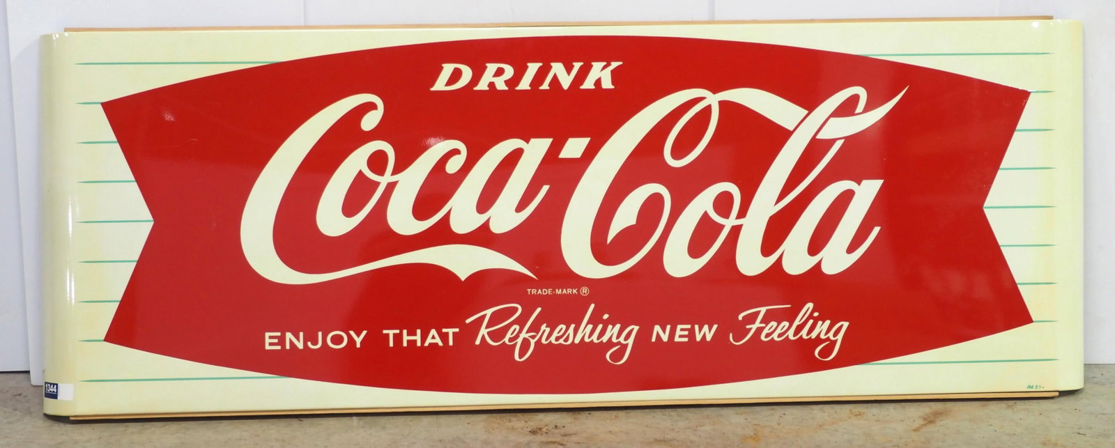 Coca Cola fishtail sign: 68"x24" SST fishtail Coca Cola "Enjoy That Refreshing New Feeling" sign with wood back frame, marked AM 81 - Excellent * * White Glove Delivery available, please contact the auction house for details 