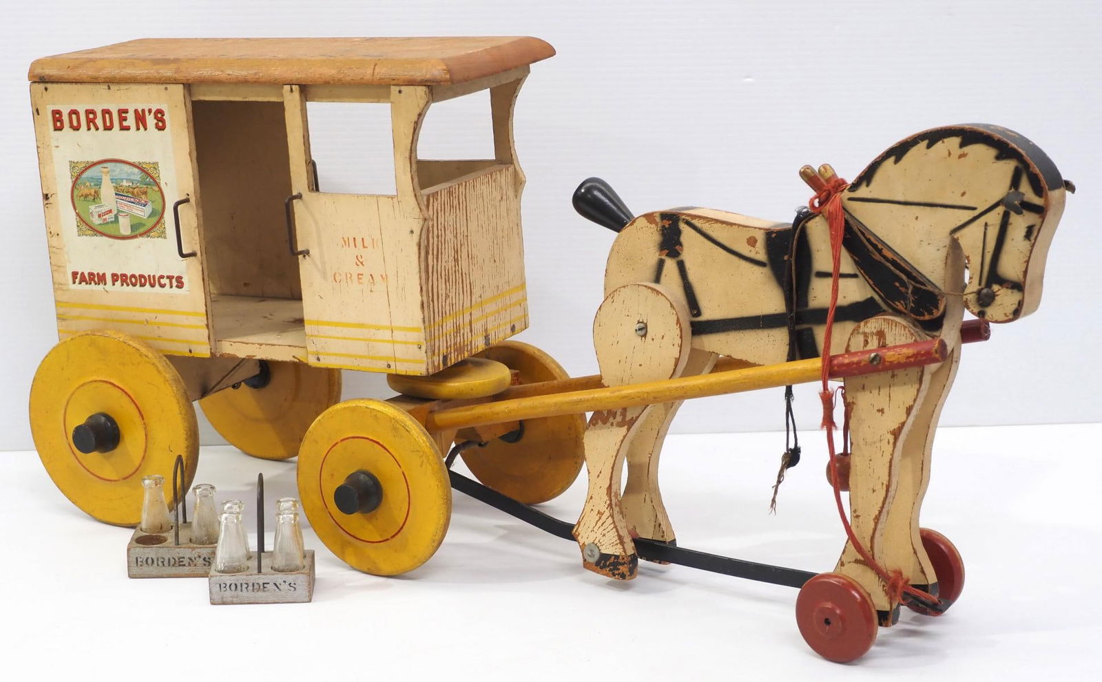 Borden's Farm Products delivery wagon pull toy: Large early wooden Borden's Farm Products horse-drawn dairy delivery wagon pull toy by Rich Toys, with 2 Borden's tin milk crates and 6 bottles, 30"L x 14"H - Good with play wear