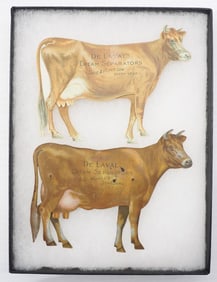 (2) DeLaval tin advertising cows