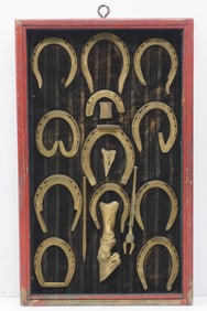 Framed display of horseshoes and tools