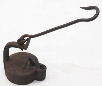 Early, primitive cast iron oil lamp