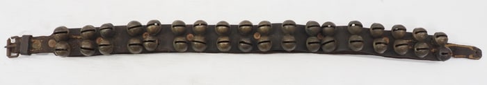 Leather strap of small brass harness bells